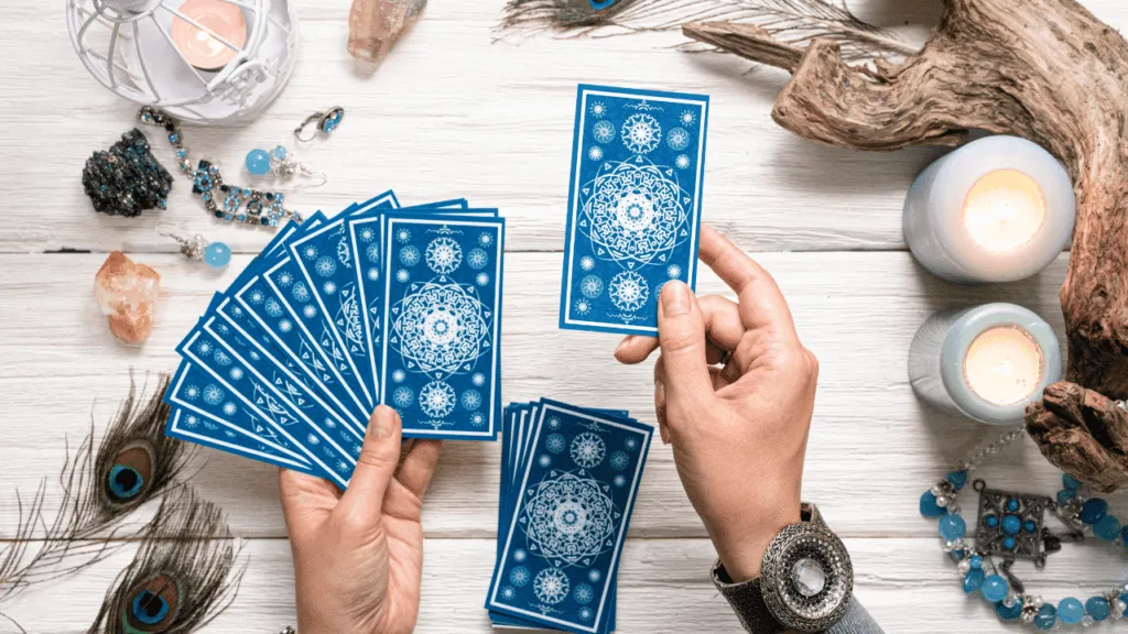 A cozy and serene home office setting, with a well-lit workspace showcasing a spread of colorful oracle cards. In the foreground, a person's hands thoughtfully selecting a card, their expression contemplative. The middle ground features a neatly arranged desk with a notebook, crystals, and other tools of the divination trade. The background depicts a warm, natural-lit window, inviting in soft daylight and a sense of tranquility. The overall atmosphere conveys a feeling of introspection, guidance, and the empowering process of overcoming challenges through the wisdom of oracle cards. Common Challenges and How to Overcome Them