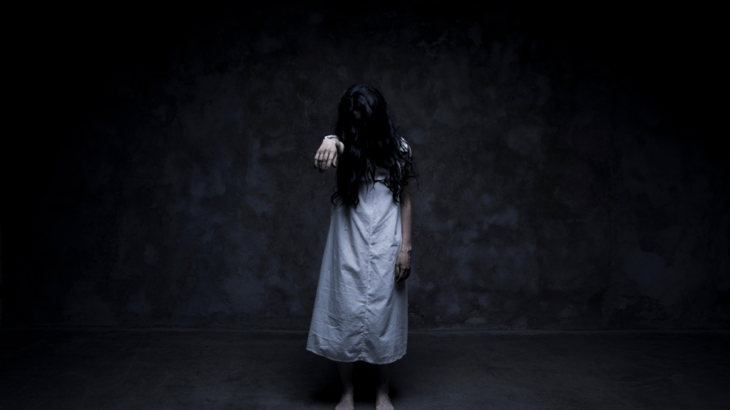 A dimly lit bedroom, the air heavy with an eerie stillness. A figure lies motionless on the bed, their skin pale and lifeless. The bedsheets are rumpled, suggesting a restless sleep. Soft, muted light filters through the curtains, casting a somber glow over the scene. The room is sparsely furnished, with a single chair and a nightstand, adding to the sense of isolation. The atmosphere is one of contemplation and unease, as if the viewer is witnessing the aftermath of a troubled dream. Dead Bodies in Dreams Based on Their Condition