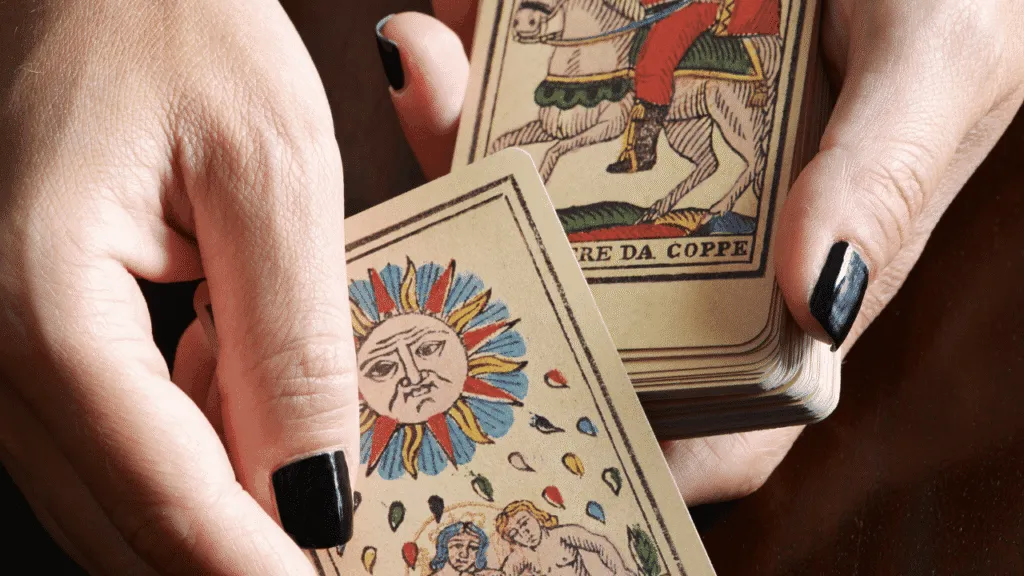 A dimly lit studio with warm, soft lighting, showcasing a table covered in scattered tarot cards, each representing a different myth or misconception about tarot. In the foreground, a hand emerges from the shadows, gently flipping over a card, revealing the true meaning behind the symbol. The middle ground features a crystal ball, a book on tarot, and other mystical artifacts, hinting at the deeper understanding of the practice. The background is shrouded in a hazy, ethereal mist, creating an air of mystery and contemplation. The overall atmosphere is one of debunking the common myths and unveiling the genuine insights of the tarot. Debunking Common Tarot Myths