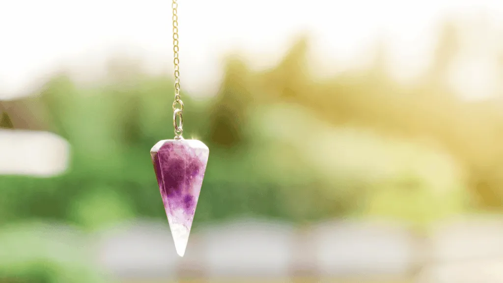 A serene, gently glowing pendulum suspended in a tranquil, ethereal environment. The pendulum's movements create a captivating energy field, its rhythmic swinging illuminating the surrounding space with a soft, cleansing light. The background is a subtly shifting gradient, transporting the viewer to a calming, meditative realm. Warm, diffused lighting casts a soothing glow, accentuating the pendulum's hypnotic sway. The composition is balanced, with the pendulum's elegant form taking center stage, inviting the viewer to become absorbed in its mesmerizing vibrations. How Does a Pendulum Work When Asking Questions Preparing Yourself and Your Pendulum