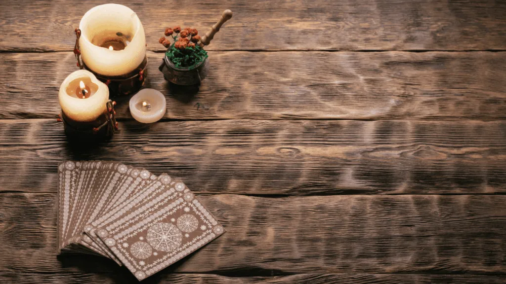 A cozy, dimly lit room with softly glowing candles and crystals adorning a wooden table. A plush, burgundy velvet armchair sits in the foreground, inviting the viewer to sink into its comforting embrace. Warm, earthy tones fill the space, creating a sense of grounded, introspective energy. Shelves of ancient tomes line the walls, hinting at the wisdom and guidance that resides within. Hanging from the ceiling, a delicate dreamcatcher catches the faint shimmer of moonlight, symbolizing the connection to the unseen realms. This sacred space is a haven for oracle card reading, where one can find clarity, insight, and a deeper understanding of the self. How to Prepare for an Oracle Card Reading