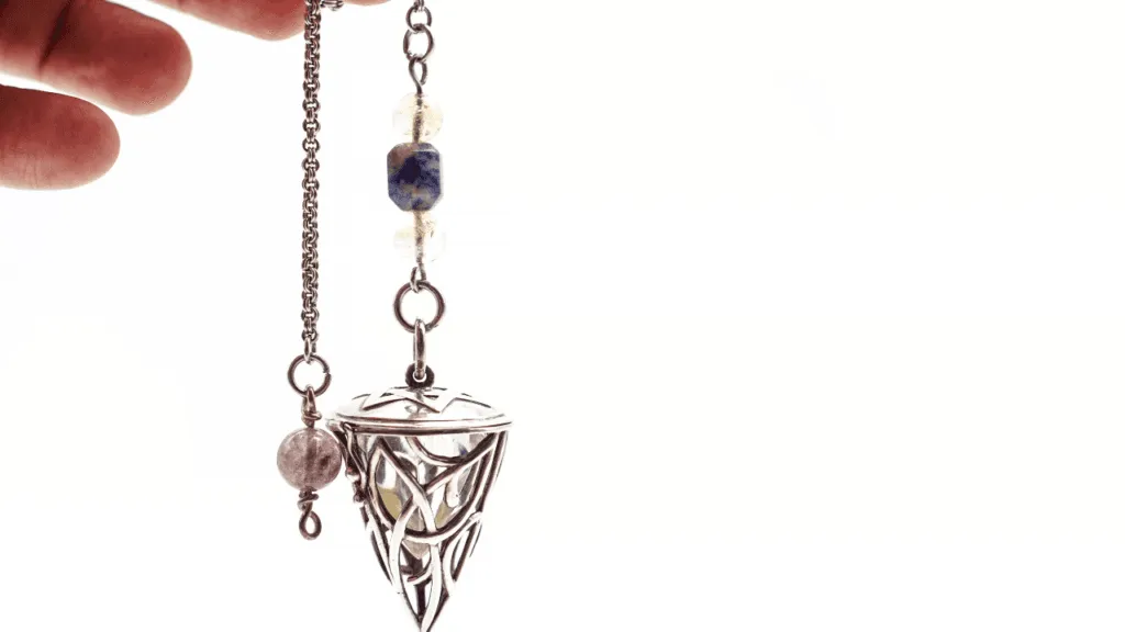 A pendulum gracefully swinging, its arc tracing a hypnotic rhythm against a soft, ethereal backdrop. The pendulum's movement is captured in a series of translucent, ghostly silhouettes, creating an interpretation of its dynamics. Warm, diffused lighting casts a contemplative glow, while the scene is framed by a minimal, monochromatic environment, allowing the pendulum's dance to take center stage. The overall impression is one of contemplation, introspection, and the subtle yet powerful insights that can be gleaned from observing this simple, timeless instrument. Interpreting Your Pendulum’s Movements