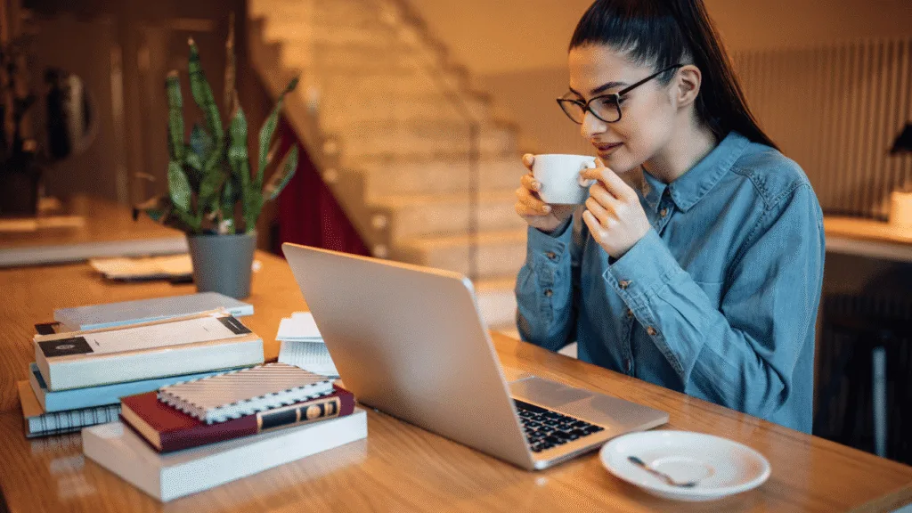 A cozy, distraction-free home office with natural lighting streaming through large windows, casting a warm glow on a minimalist desk setup. A potted plant, a pair of noise-cancelling headphones, and a sleek laptop create a serene, productivity-boosting atmosphere. The space is clutter-free, with just the essentials for focused work - a mug of steaming coffee, a pen, and a notebook. Bookshelves line the walls, hinting at a wealth of knowledge. Soft textures, like a plush rug and a comfortable office chair, invite the user to settle in and immerse themselves in their task. The overall vibe is one of calm, clarity, and uninterrupted concentration. How to Avoid Distractions and Stay Focused Creating a Distraction-Free Environment